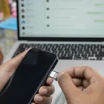 WhatsApp SIM binding rule – business owner inserting the registered SIM into the phone